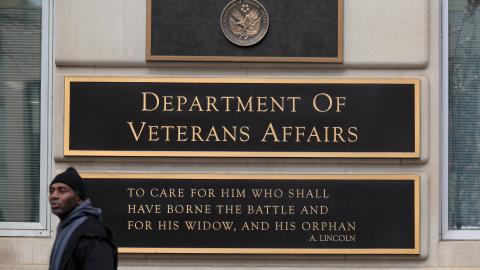 A person walks past the Department of Veterans Affairs headquarters a block from the White House on March 06, 2025 in Washington, DC. As part of President Donald Trump and the Department of Government Efficiency's work to downsize the federal government, Secretary of Veterans Affairs Doug Collins said the department will reduce it's workforce by 15-percent, or about 80,000 jobs. (Photo by Chip Somodevilla/Getty Images)