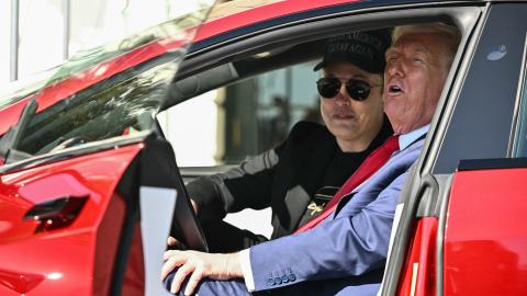 President Donald Trump and Elon Musk speak to the press as they sit in a Tesla vehicle on March 11, 2025, in Washington, DC. (Mandel Ngan/AFP via Getty Images)