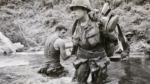 US troops of the 23rd (Americal) Infantry Division ford a river about 11 miles west of Chu Lai in South Vietnam (then the Republic of Vietnam, or RVN), 15th August 1971. The GIs, members of Bravo Company, 4th Battalion, 31st Infantry, are among the last U. S. combat troops still operating in the field. US B-52 aircraft bombed suspected communist troop concentrations near the demilitarized zone, on August 15th, following more shelling and ground assaults earlier on August 15th. More than 750 rounds of mortar