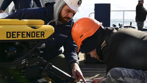 Royal Australian Navy sailors perform maintenance on a remotely operated vehicle during the Australia, UK, and US (AUKUS) Pillar II Subsea and Seabed Warfare Event Two / Integrated Battle Problem 25.1 on December 6, 2024, in the Atlantic Ocean. (US Navy photo)