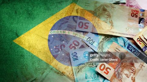 Brazilian reais cash bills and flag of Brazil (economy, finance, business, inflation, crisis)