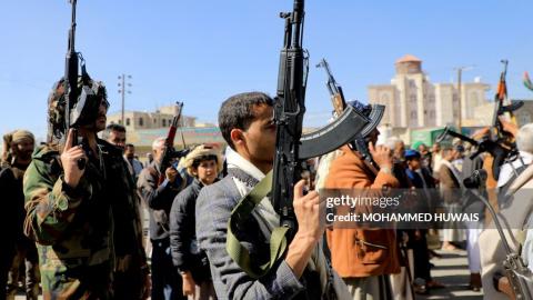 TOPSHOT - Huthi fighters brandish their weapons during a march in solidarity with the Palestinian people in the Huthi-controlled capital Sanaa on January 11, 2024, amid the ongoing battles between Israel and the militant Hamas group in Gaza. Heavy air strikes pounded rebel-held cities in Yemen early on January 12, 2024, the Huthi rebels' official media and AFP correspondents said. The capital Sanaa, Hodeida and Saada were all targeted, the Huthis' official media said, blaming "American aggression with Briti