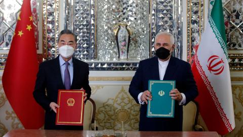 Iranian Foreign Minister Mohammad Javad Zarif and Chinese Foreign Minister Wang Yi pose for a picture after signing a 25-year strategic cooperation pact on March 27, 2021. (Getty Images)