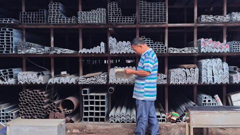 A man works at a steel market in southwest China's Chongqing Municipality on Monday, June 2, 2025. (Li Hongbo via Getty Images)