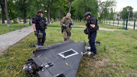 Ukrainian explosives experts and police officers examine parts of a Shahed 136 military drone following an air attack in Kharkiv on June 4, 2025, amid the Russian invasion of Ukraine. (Sergey Bobok via Getty Images)