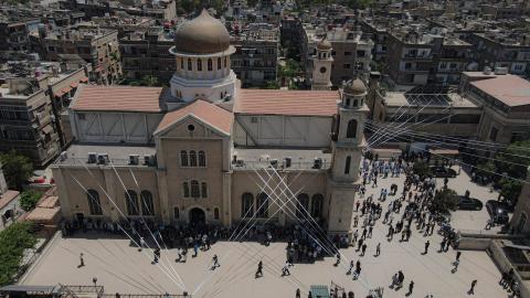 An aerial view shows a mass funeral ceremony being held at the Holy Cross Church in the Al-Qassaa neighborhood of Damascus, Syria, on June 24, 2025. (Izettin Kasim via Getty Images)