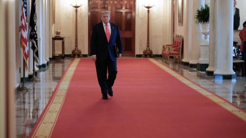 United States President Donald Trump walks through the Cross Hall as he arrives for a "One, Big, Beautiful" event in the East Room of the White House on June 26, 2025, in Washington, DC. (Chip Somodevilla via Getty Images)