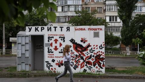 A woman walks past a concrete shelter painted in the style of Ukrainian embroidered ornamentation in a residential district on May 17, 2025 in Kherson, Ukraine. (Photo by Ivan Antypenko/Suspilne Ukraine/JSC "UA:PBC"/Global Images Ukraine via Getty Images)