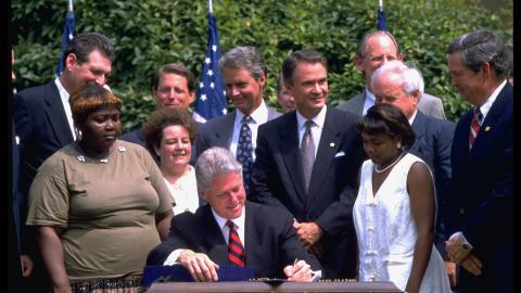President Bill Clinton signs a welfare reform bill in the White House Rose Garden on August 21, 1996. (Dirck Halstead via Getty Images)