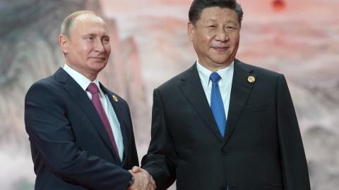 President Vladimir Putin shakes hands with President Xi Jinping during a welcoming ceremony at the Shanghai Cooperation Organization Council of Heads of State in Qingdao, China, on June 10, 2018. (Sergei Guneyev via Getty Images)