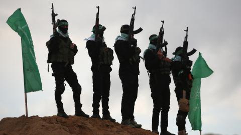 Palestinian Hamas militants gather at the site of the handing over of the bodies of four Israeli hostages in Khan Yunis in the southern Gaza on February 20, 2025. (Eyad Baba via Getty Images)
