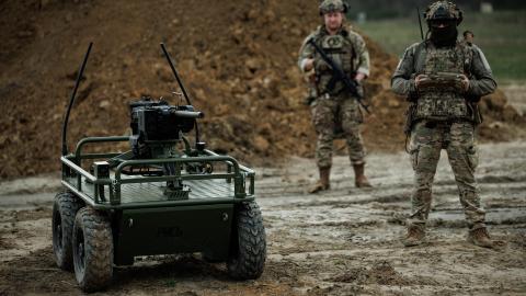 Ukrainian military personnel control the unmanned ground vehicle platform Rys Pro equipped with a remote-controlled machine-gun turret during training on April 18, 2025, in an unspecified area of Ukraine. (Serhii Mykhalchuk via Getty Images)