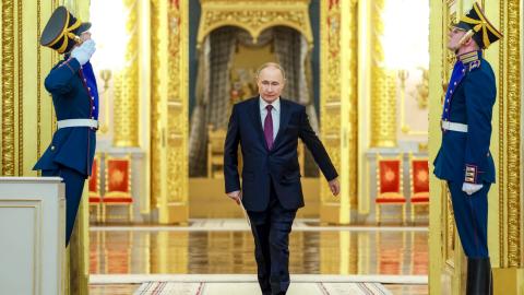 In this pool photograph distributed by the Russian state agency Sputnik, Vladimir Putin enters a hall to meet with graduates of higher military educational institutions at the Kremlin on June 23, 2025. (Alexander Kazakov via Getty Images)
