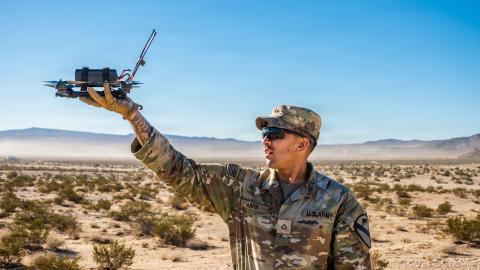 A US infantryman releases a Neros Archer small unmanned aircraft system for a test flight at the Fort Irwin in California on October 25, 2025. (US Army)