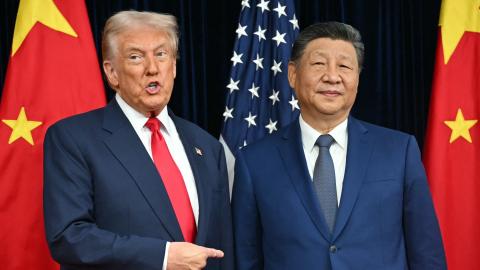 US President Donald Trump (L) and China's President Xi Jinping greet each other as they arrive for talks at the Gimhae Air Base, located next to the Gimhae International Airport in Busan on October 30, 2025. Donald Trump and Chinese leader Xi Jinping will seek a truce in their bruising trade war on October 30, with the US president predicting a "great meeting" but Beijing being more circumspect. (Photo by ANDREW CABALLERO-REYNOLDS / AFP) (Photo by ANDREW CABALLERO-REYNOLDS/AFP via Getty Images)