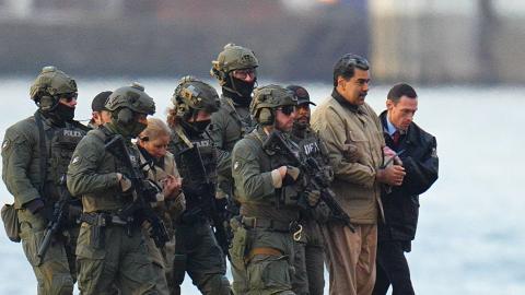 Nicolas Maduro and his wife, Cilia Flores, are seen in handcuffs after landing at a Manhattan helipad, escorted by heavily armed federal agents as they make their way into an armored car en route to a federal courthouse on January 5, 2026. (Getty Images)