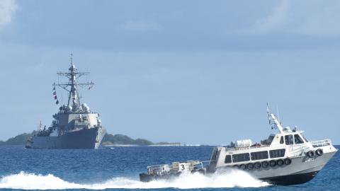 A tugboat crosses in front of the Arleigh Burke-class guided-missile destroyer USS Stethem as the ship arrives in Diego Garcia on January 3, 2024. (US Navy)