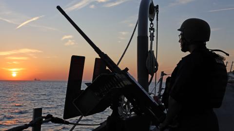 A US Navy fire controlman on the Arleigh Burke–class guided-missile destroyer USS Roosevelt stands on lookout in the Arabian Sea on December 8, 2025. (US Navy)