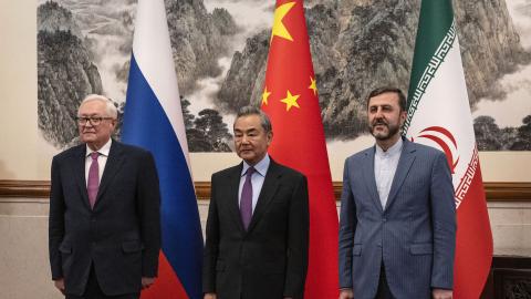 Caption China’s Foreign Minister Wang Yi welcomes Russia's Deputy Foreign Minister Sergey Ryabkov and Iran’s Deputy Foreign Minister Kazeem Gharibabadi at the Diaoyutai State Guesthouse in Beijing on March 14, 2025. (Getty Images)