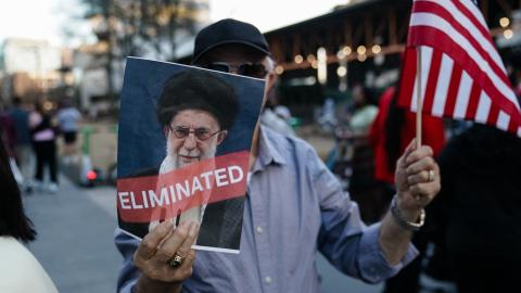 A man holds a US flag and a sign with a portrait of Iranian Supreme Leader Ayatollah Ali Khamenei on February 28, 2026, in Atlanta, Georgia. (Getty Images)