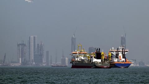 Commercial vessels are pictured offshore in Dubai on March 11, 2026. New attacks hit three commercial ships in the Gulf on March 11, with one of the vessels in flames as Iran pressed its campaign against its oil-exporting neighbours, threatening shipping in the Strait of Hormuz and plunging the global energy economy into crisis. (Photo by AFP via Getty Images) / Attention editors: AFP covers the war in the Middle East through its extensive regional network, including bureaus in Tehran, Jerusalem and several
