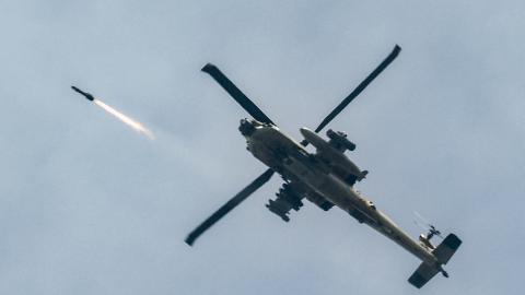 An Israeli Air Force AH-64 Apache attack helicopter fires rockets on March 18, 2026. (Getty Images)