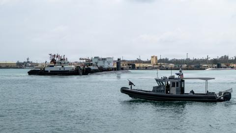 Los Angeles-class fast-attack submarine USS Jefferson City (SSN 759) and a harbor patrol boat transits Apra Harbor at Naval Base Guam, April 20, 2026. Assigned to Commander, Submarine Squadron 15 at Polaris Point, Naval Base Guam, Jefferson City is one of five fast-attack submarines forward-deployed in the Pacific. Renowned for their unparalleled speed, endurance, stealth, and mobility, fast-attack submarines serve as the backbone of the Navy's submarine force, ensuring readiness and agility in safeguardin