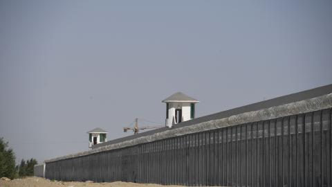 This photo taken on May 31, 2019 shows watchtowers on a high-security facility near what is believed to be a re-education camp where mostly Muslim ethnic minorities are detained, on the outskirts of Hotan, in China's northwestern Xinjiang region. - As many as one million ethnic Uighurs and other mostly Muslim minorities are believed to be held in a network of internment camps in Xinjiang, but China has not given any figures and describes the facilities as "vocational education centres" aimed at steering peo