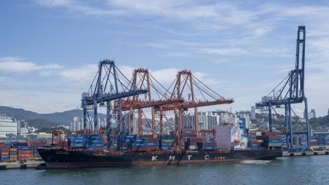 Rusty KMTC Line ship and commercial port cranes loading containers onto a container ship in Busan Port, Korea on July 31, 2025. Illustration of global shipping. (Photo by Antoine Boureau / Hans Lucas via AFP) (Photo by ANTOINE BOUREAU/Hans Lucas/AFP via Getty Images)