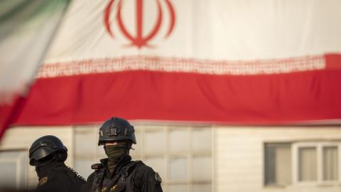 Armed members of Iran's police special forces monitor an area while standing on an armored military vehicle under a country flag during a pro-Government rally in downtown Tehran, Iran, on January 12, 2026. The rally is held in Tehran against the recent anti-government unrest, opposition to the U.S. and Israel in Iran, and in support of Supreme Leader Ayatollah Ali Khamenei. (Photo by Morteza Nikoubazl/NurPhoto via Getty Images)