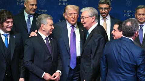 US President Donald Trump (C), flanked by President of Kazakhstan's President Kassym-Jomart Tokayev (R) and Uzbekistan's President Shavkat Mirziyoyev (L), gathers with leaders during a group photo during the inaugural meeting of the "Board of Peace" at the US Institute of Peace in Washington, DC, on February 19, 2026. President Trump on Thursday gathers allies to inaugurate the "Board of Peace," his new institution focused on progress on Gaza but whose ambitions reach much further. Around two dozen world le