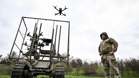 A soldier with the call sign ''Pavuk'' (''Spider'') watches a drone take off from a ground robotic complex during trials at a training ground on April 10, 2026. Developers of the robotic systems, along with soldiers from two brigades operating in the Zaporizhzhia direction, test unmanned ground vehicles (UGVs) at the site. Combat medics also train in operating logistical platforms. Before deployment in combat, the UGVs are first tested by the developers themselves, followed by the military. (Photo by Dmytro