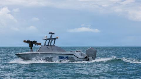 An unmanned surface vehicle (USV) sails off the coast of Key West, Fla., during the annual Fleet Experimentation (FLEX) 2026 event, April 24, 2026. Hosted by U.S. Naval Forces Southern Command/U.S. 4th Fleet April 24-30, the exercise integrates commercially developed unmanned systems and artificial intelligence with traditional manned naval platforms. FLEX 2026 features comprehensive collaboration across the Department of War and industry to demonstrate a sophisticated kill chain that successfully found, tr