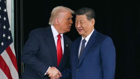  US President Donald Trump (L) and China's President Xi Jinping shake hands as they leave after their talks at the Gimhae Air Base, located next to the Gimhae International Airport in Busan on October 30, 2025. US President Donald Trump and China's leader Xi Jinping opened on October 30 their first face-to-face meeting in six years, seeking a truce to end a trade war that has roiled the world economy. (Photo by ANDREW CABALLERO-REYNOLDS / AFP via Getty Images)