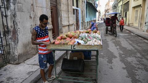A street vendor wearing a T-shirt bearing a US flag waits for customers on a street in Havana on May 18, 2026. (Getty Images)