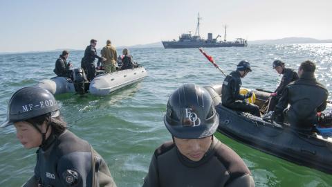 Sailors from the US Navy Explosive Ordnance Disposal Mobile Unit 1 and the Japan Maritime Self-Defense Force prepare for a mine-sweep exercise dive using an unmanned underwater vehicle to detect training mines in Japan’s Ise Bay on February 4, 2020. (US Air Force)