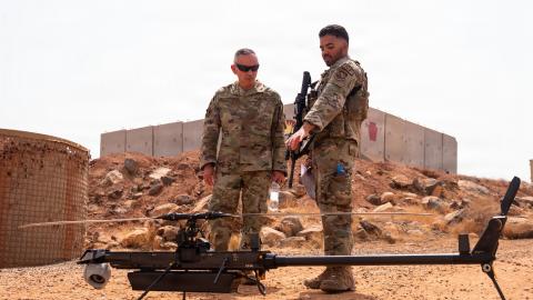 U.S. Air Force Col. Valentin Maldonado, 406th Air Expeditionary Wing deputy commander, left, is shown a small unmanned aerial system by Senior Airman Luis Oriz-Ortiz, 776th Expeditionary Air Base Squadron security forces member, right, at Chabelley Airfield, Djibouti, May 20, 2026. Maldonado's visit reinforced the importance of mission readiness, force development and supporting personnel operating in a dynamic expeditionary environment. (U.S. Air Force photo by Senior Airman Luis Gomez) Read less