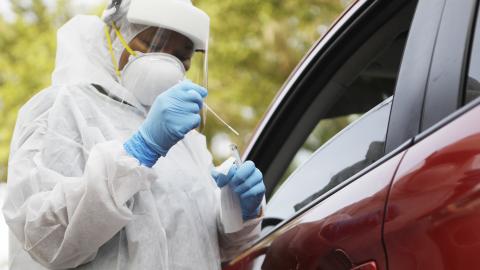 A healthcare worker administers a coronavirus test to a patient at the Lee Davis Community Resource Center on June 25, 2020, in Tampa, Florida. (Getty Images)