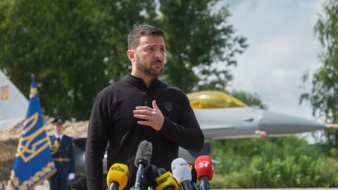 President of Ukraine Volodymyr Zelenskyi stands in front of the first General Dynamics F-16 Fighting Falcon received by Ukraine as he congratulates Ukrainian military on the Day of Ukrainian Air Force on August 4, 2024 in Unspecified, Ukraine. At the event for the Day of Ukrainian Air Force with the participation of President of Ukraine Volodymyr Zelenskyi, the first General Dynamics F-16 Fighting Falcons received by Ukraine were demonstrated. (Photo by Vitalii Nosach/Global Images Ukraine via Getty Images)