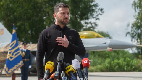 President of Ukraine Volodymyr Zelenskyi stands in front of the first General Dynamics F-16 Fighting Falcon received by Ukraine as he congratulates Ukrainian military on the Day of Ukrainian Air Force on August 4, 2024 in Unspecified, Ukraine. At the event for the Day of Ukrainian Air Force with the participation of President of Ukraine Volodymyr Zelenskyi, the first General Dynamics F-16 Fighting Falcons received by Ukraine were demonstrated. (Photo by Vitalii Nosach/Global Images Ukraine via Getty Images)