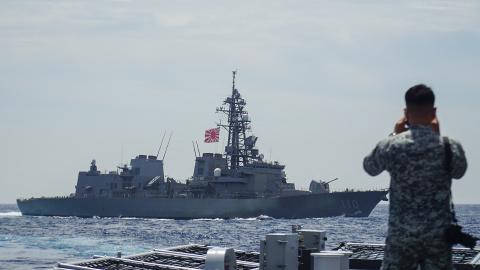 A member of the Philippine Navy looks out at as the Japan Maritime Self-Defense Force destroyer JS Takanami during a joint maritime exercise in the South China Sea on June 14, 2025. (Getty Images)