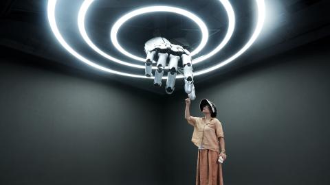 A visitor interacts with a mechanical hand at the Robot Mall on August 4, 2025, in Beijing. (Getty Images)