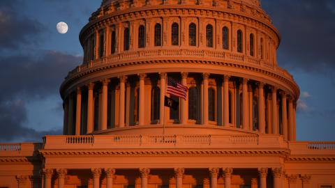 The moon is visible behind the US Capitol on December 2, 2025, in Washington, DC. (Getty Images) Share to Twitter