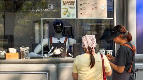 Customers place an order at a robot-operated coffee kiosk on March 25, 2026, in Shenzhen, China. (Getty Images)