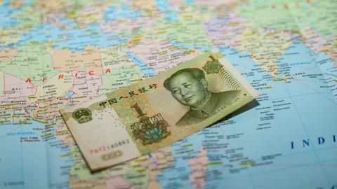 A Chinese yuan banknote on a world map in March 2026. (Getty Images