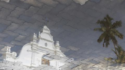 A church is reflected in a puddle following rain in Kochi, India, on May 22, 2026. (Getty Images)