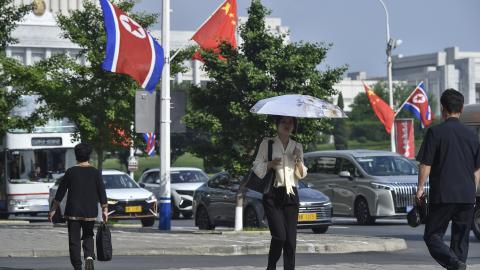 The national flags of North Korea and China are displayed on a street in Pyongyang on June 8, 2026, as Xi Jinping arrives for his first official visit to North Korea since 2019. (Getty Images)