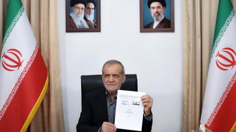 Iranian President Masoud Pezeshkian signs the memorandum of understanding at his office in Tehran, Iran, on June 18, 2026. (Iranian Presidency via Getty Images)
