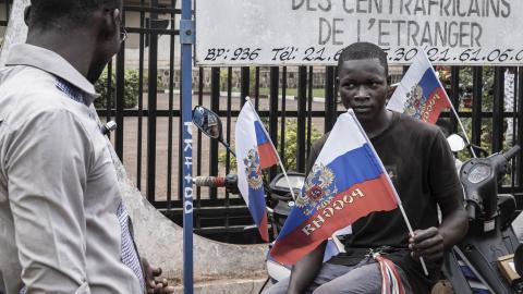 A demonstrator holds a flag with the emblem of Russia in Bangui, Central African Republic, on March 22, 2023, while sitting on a motorcycle during a march in support of Russia’s and China’s presence in the country. (Getty Images)