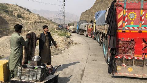 A tea vendor stands by stalled vehicles near the closed Pakistan-Afghanistan border town of Torkham on October 19, 2025. (Getty Images)